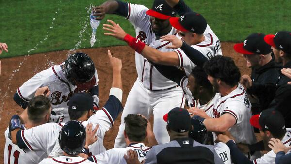 Opening Day 2018: The Braves congratulate Nick Markakis  after his ninth-inning home run produced a win over the Philadelphia Phillies on March 29, 2018. 