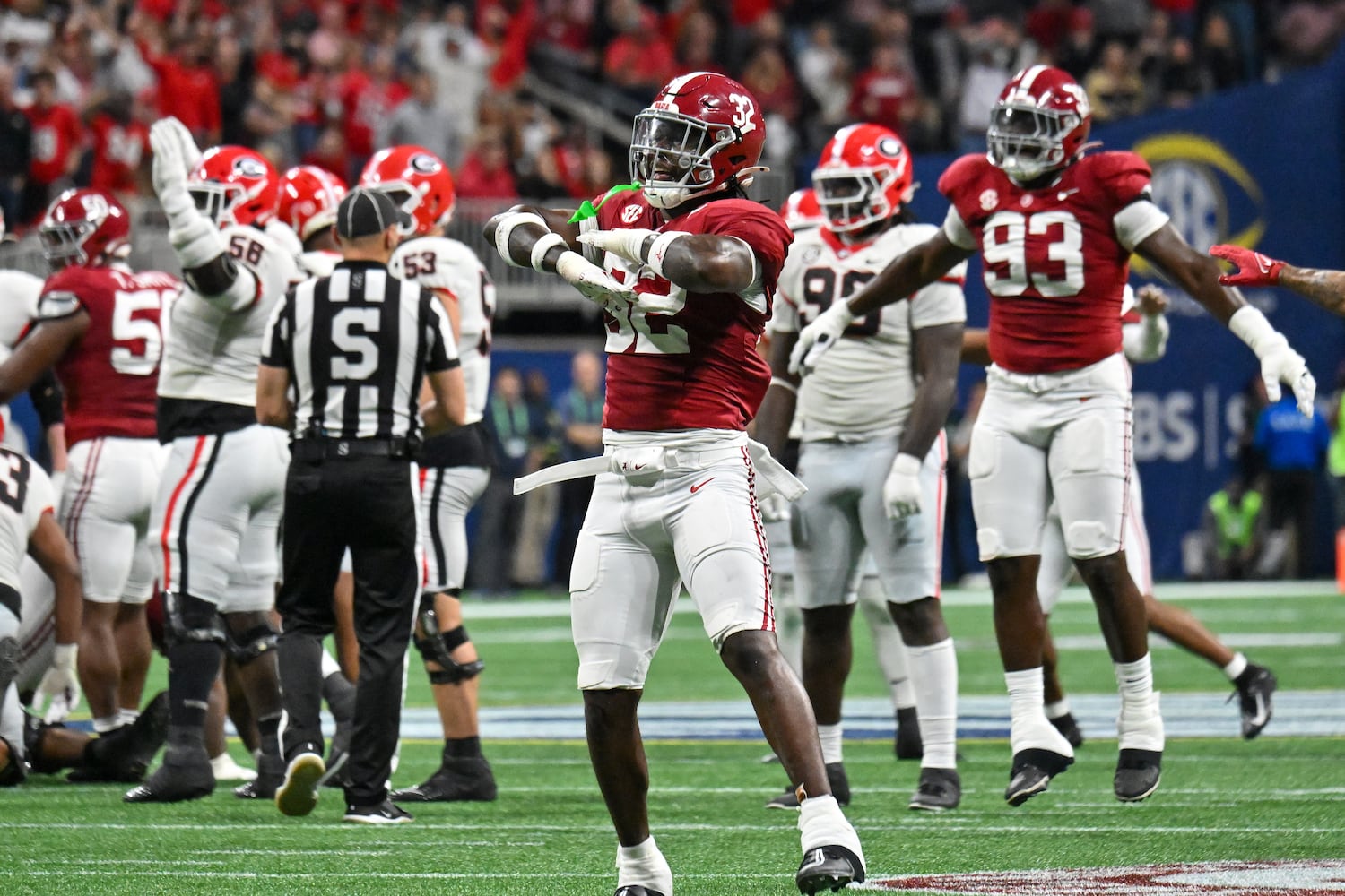 Alabama Crimson Tide defenders Deontae Lawson (32) and Jah-Marien Latham (93) signal a missed field goal by Georgia Bulldogs’ Peyton Woodring during the first half of the SEC Championship football game at the Mercedes-Benz Stadium in Atlanta, on Saturday, December 2, 2023. (Hyosub Shin / Hyosub.Shin@ajc.com)