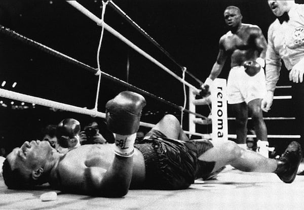 Champion Mike Tyson lies on his back after being decked by challenger James "Buster" Douglas, standing in background, as referee Octavio Meyron keeps counting in the 10th round of the scheduled 12-round heavyweight championship bout at the Tokyo Dome in 1990.