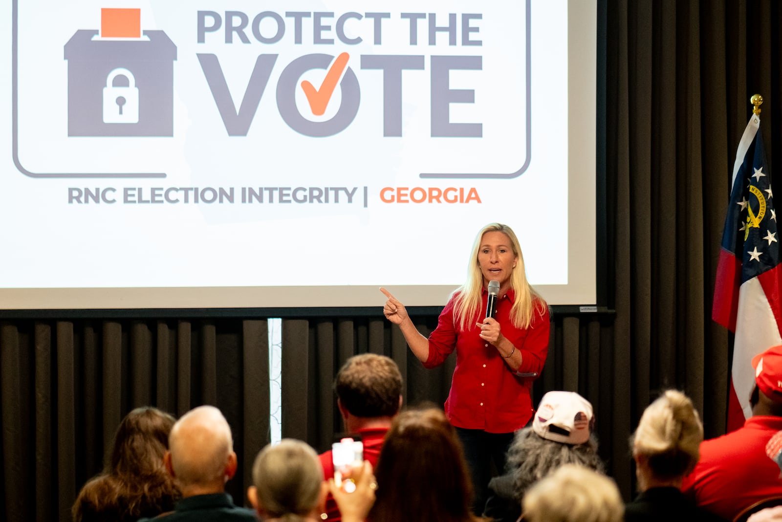 U.S Rep. Marjorie Taylor Green speaks to the crowd at a "protect the vote" rally in Rome. “I have stood with you all on protecting our elections, and I am so proud to tell you again that I objected to Joe Biden’s Electoral College votes in 2020,” she told the crowd, referring to an election in Georgia that was confirmed by two recounts — including a hand count of every ballot. (Ben Hendren for the Atlanta Journal-Constitution)