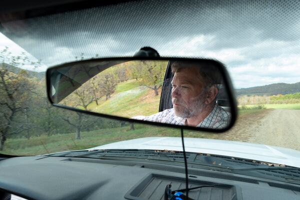 Ray Covington, superintendent of the Georgia Mountain Research and Education Center near Blairsville, drives through the facility’s orchard on Thursday, Oct. 31, where he’s helping grow 138 varieties of heritage apples. (Ben Gray for the AJC)