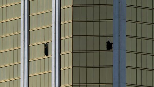 The damaged windows on the 32nd floor room that was used by the shooter in the Mandalay Hotel after a gunman killed at least 58 people and wounded more than 500 others when he opened fire on a country music concert in Las Vegas, Nevada on October 2, 2017. 
Police said the gunman, a 64-year-old local resident named as Stephen Paddock, had been killed after a SWAT team responded to reports of multiple gunfire from the 32nd floor of the Mandalay Bay, a hotel-casino next to the concert venue. / AFP PHOTO / Mark RALSTON        (Photo credit should read MARK RALSTON/AFP/Getty Images)