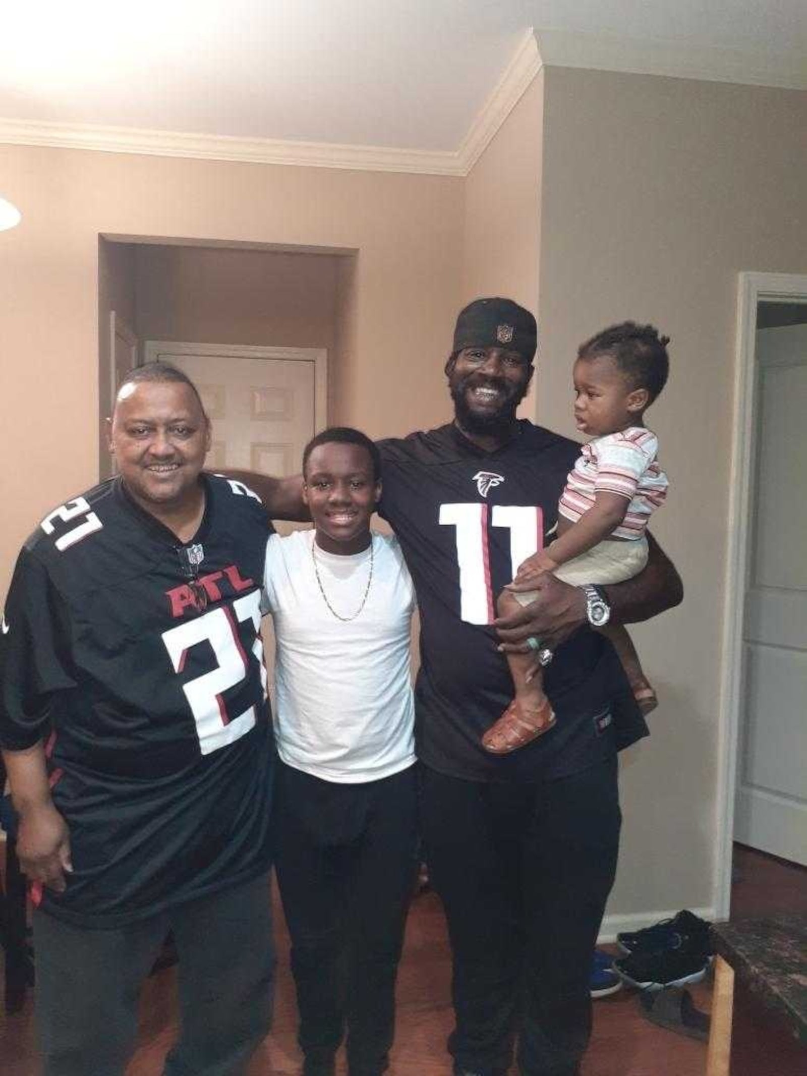 Ronald Barner (left) loved his family and the Atlanta Falcons. He was shot to death last March while walking in his southwest Atlanta neighborhood.