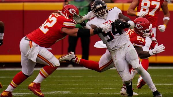 Atlanta Falcons linebacker Foyesade Oluokun is tackled by Kansas City Chiefs center Austin Reiter after intercepting a pass from Chiefs quarterback Patrick Mahomes during the second half Sunday, Dec. 27, 2020, in Kansas City, Mo. (Jeff Roberson/AP)