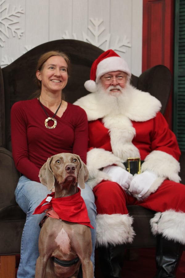 Cathy Gable and her dog Koda take pictures with Santa at Perimeter Mall in Dunwoody on Monday, November 18, 2024. (Taylor Croft / AJC)