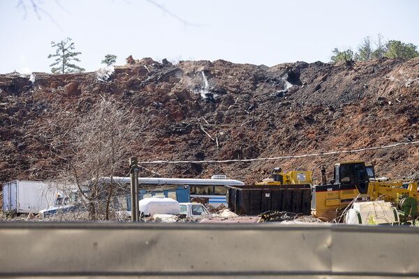 Smoke can be seen rising from an unlicensed landfill, located at 7635 Bishop Road, in South Fulton, Wednesday, February 13, 2019. (ALYSSA POINTER/ALYSSA.POINTER@AJC.COM)