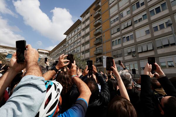 Faithfuls wait a Pope Francis appearing at a window of the Agostino Gemelli Polyclinic in Rome, Sunday, March 23, 2025, for the first time after being admitted on Feb. 14 with bronchitis that afterward worsened into bilateral pneumonia. (AP Photo/Riccardo De Luca)