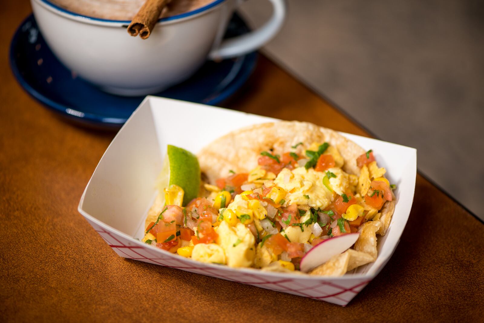 Taqueria el Tesoro Migas breakfast taco with egg, queso chihuahua, crispy tortilla chips, mesquite corn and pico de gallo.