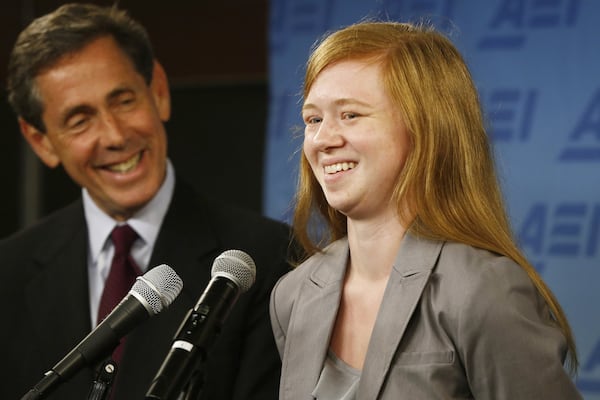 Abigail Fisher, who sued the University of Texas when she was not offered a spot at the university’s flagship Austin campus in 2008, with Edward Blum of the Project on Fair Representation, speaks at a news conference at the American Enterprise Institute in Washington on Monday, June 24, 2013. The U.S. Supreme Court ruling on affirmative action in higher education will have “no impact” on the University of Texas’ admissions policy, school president Bill Powers said Monday, noting UT will continue to use race as a factor in some cases. (Charles Dharapak/AP)