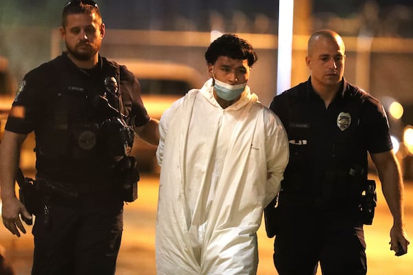 Suspect Jason Banegas is escorted by Hollywood police to be transferred to the Broward County Jail. Banegas is accused of killing Hollywood Police Officer Yandy Chirino. (Carline Jean/South Florida Sun Sentinel/TNS)