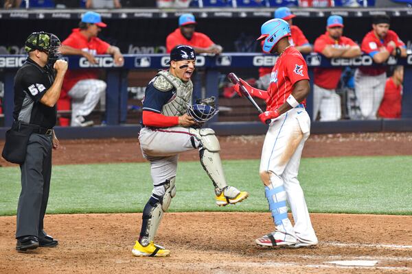 Atlanta Braves catcher William Contreras, center, reacts after Miami Marlins' Jorge Soler, right, struck out to end a baseball game Saturday May 21, 2022, in Miami. (AP Photo/Gaston De Cardenas)