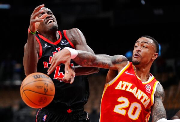 Toronto Raptors forward Pascal Siakam (43) is fouled by Atlanta Hawks forward John Collins (20) during the first half of an NBA basketball game Friday, Feb. 4, 2022, in Toronto. (Frank Gunn/The Canadian Press via AP)