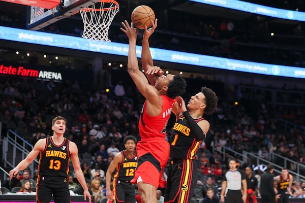 Toronto Raptors forward Scottie Barnes (4) attempts a shot against Atlanta Hawks forward Jalen Johnson (1) during the first half at State Farm Arena, Thursday, Jan. 23, 2025, in Atlanta. Johnson was hurt on the play. (Jason Getz / AJC)