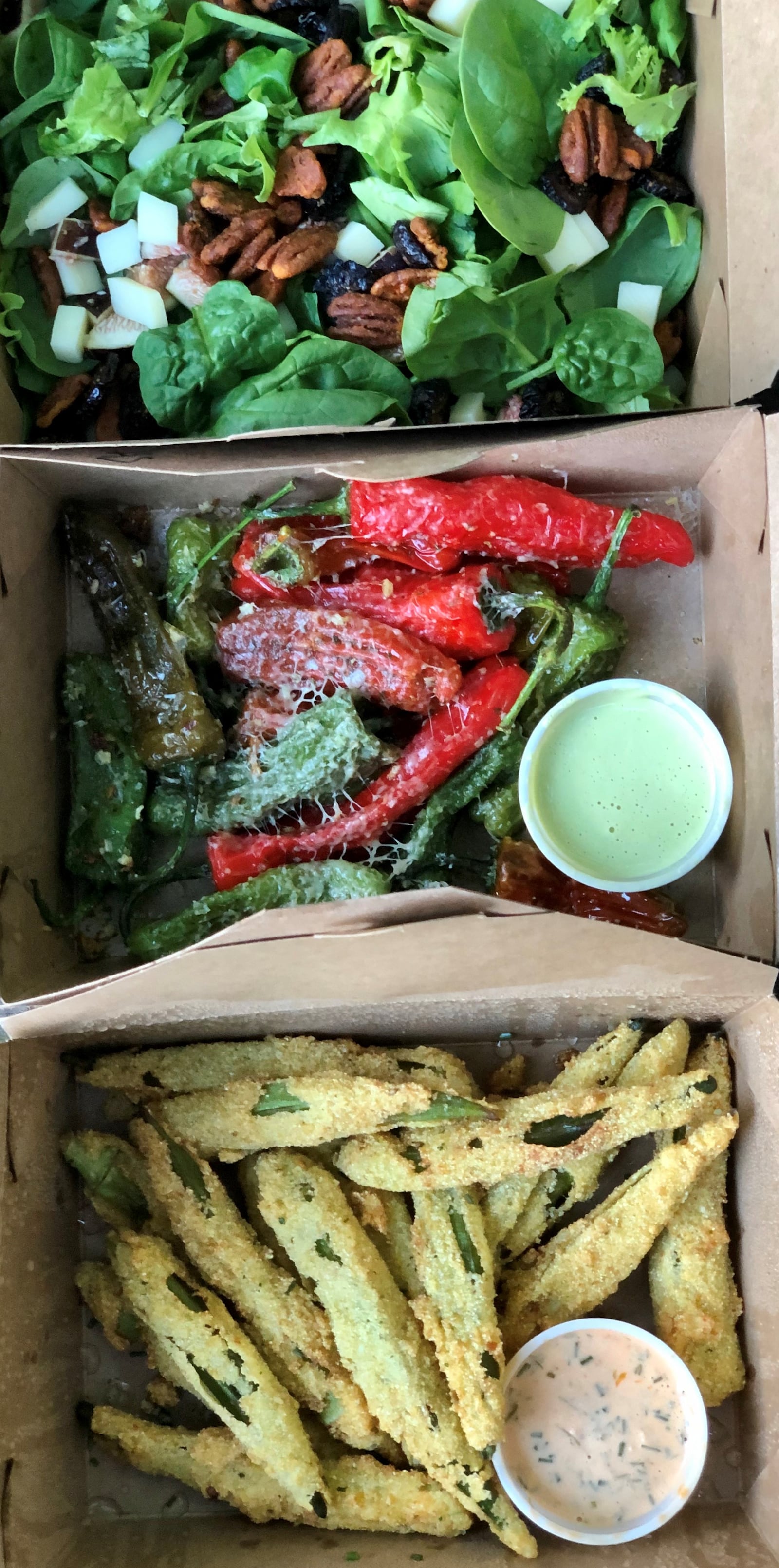 This takeout order from A Mano includes fig salad, blistered shishitos and fried okra. CONTRIBUTED BY WENDELL BROCK
