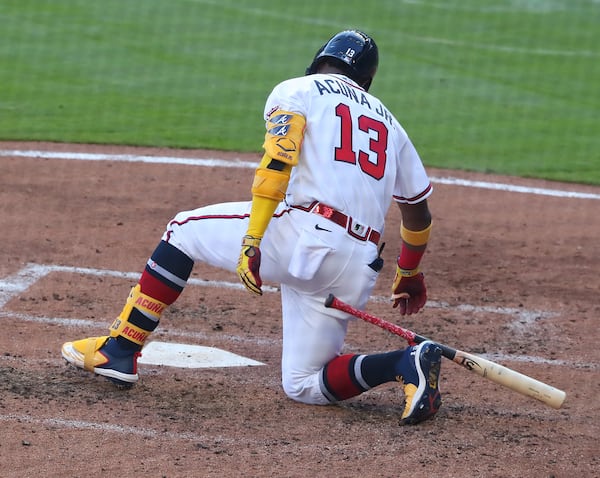 Braves outfielder Ronald Acuna goes down at the plate as he flies out in the fourth inning of the second game of a doubleheader Sunday, April 25, 2021, against the Arizona Diamondbacks at Truist Park in Atlanta. Acuna went hitless across the two-game set. (Curtis Compton / Curtis.Compton@ajc.com)