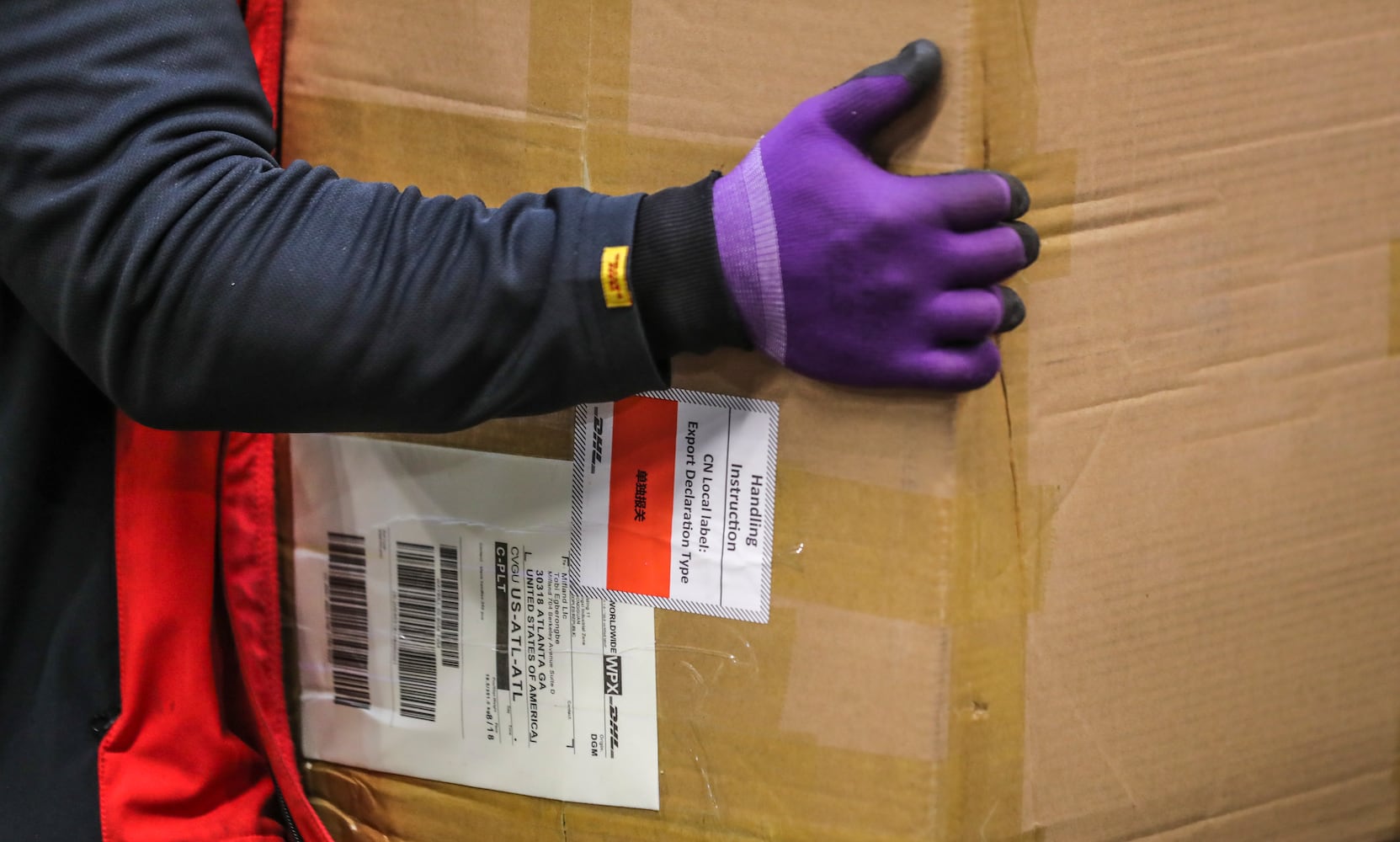 December 15, 2022 ATLANTA: Handling the boxes while sorting packages and readying them for transport. (John Spink / John.Spink@ajc.com)

