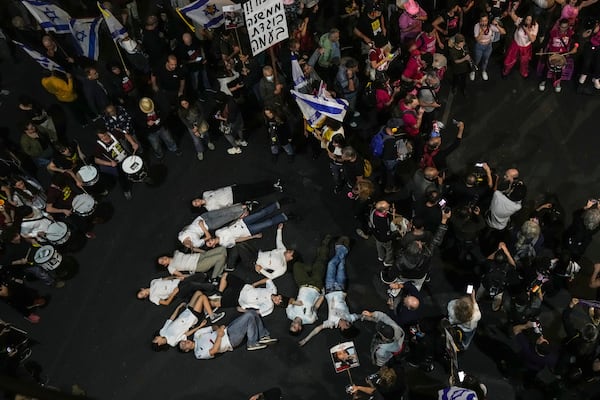 People gather to protest against Prime Minister Benjamin Netanyahu's government and call for the release of hostages held in the Gaza Strip by the Hamas militant group, in Tel Aviv, Israel, Saturday, Nov. 23, 2024. (AP Photo/Maya Alleruzzo)