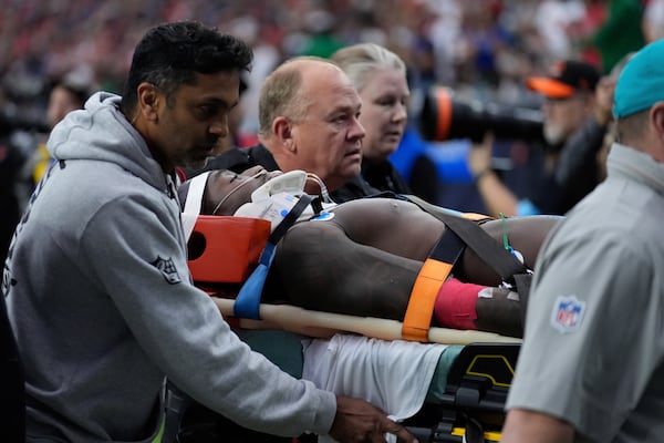 Miami Dolphins wide receiver Grant DuBose (88) is carted off the field after being injured during the second half of an NFL football game against the Houston Texans, Sunday, Dec. 15, 2024, in Houston. (AP Photo/Ashley Landis)