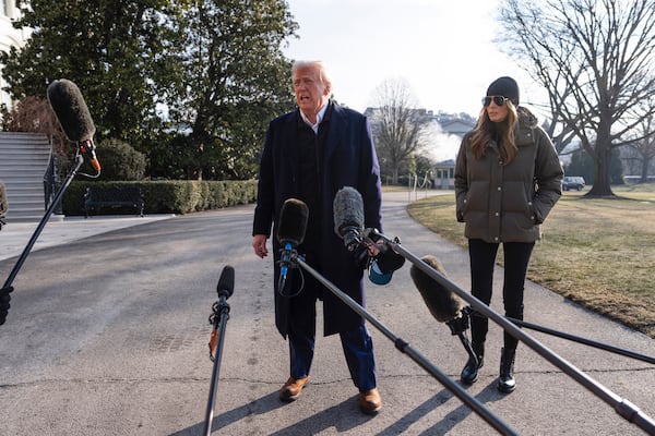 First lady Melania Trump looks on as President Donald Trump speaks with reporters before boarding Marine One on the South Lawn of the White House, Friday, Jan. 24, 2025, in Washington. (AP Photo/Evan Vucci)