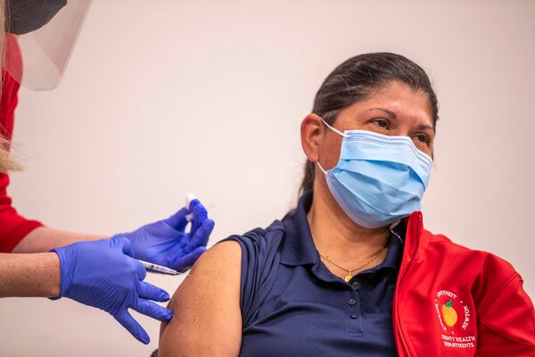 A Gwinnett, Rockdale and Newton County Gwinnett, Rockdale and Newton County Health Department employee receives the COVID-19 Pfizer BioNTech vaccination in Lawrenceville. (Alyssa Pointer / Alyssa.Pointer@ajc.com)