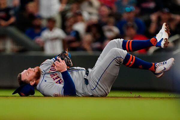 New York Mets second baseman Travis Blankenhorn falls after catching a fly ball from Atlanta Braves' Ronald Acuna Jr. duirng the sixth inning of a baseball game Wednesday, June 30, 2021, in Atlanta. (AP Photo/John Bazemore)