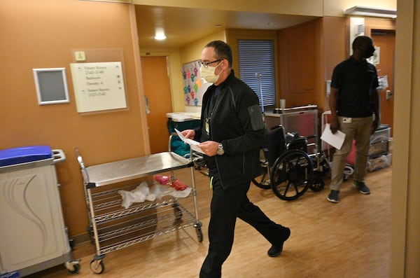 Dr. Hisham Qutob rushes to check on patients at the Intensive Care Unit of Northeast Georgia Medical Center in Braselton. "I think for physicians, nurses, and non-medical people, we are all just about ready to be done with this," he says. "But I think the question that is out there and I have an answer for this, is what does a post-pandemic life like look like if this virus never goes away?" (Hyosub Shin / Hyosub.Shin@ajc.com)
