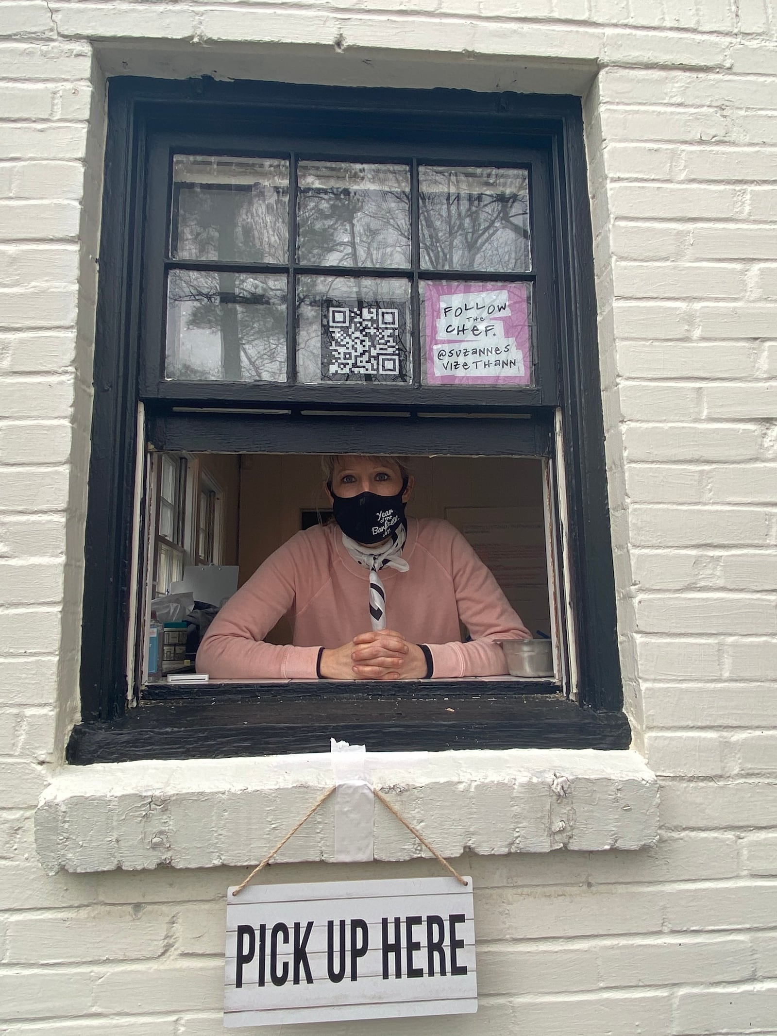 Chef and restaurateur Suzanne Vizethann stands at the pickup window for her new pop-up, Milkdrop Biscuits, in the office next to her popular Buttermilk Kitchen. Ligaya Figueras/ligaya.figueras@ajc.com