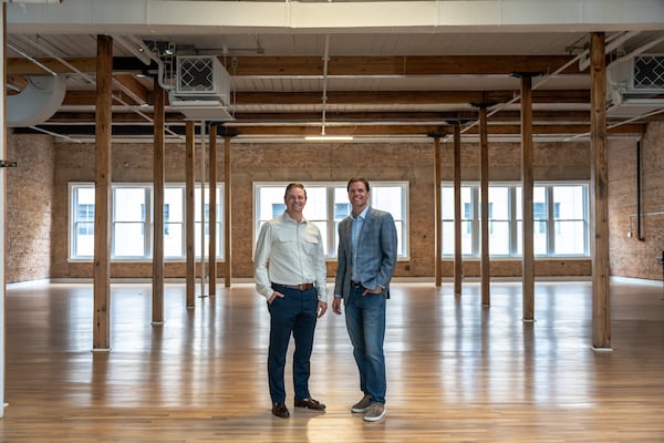 Jon Birdsong (left) and David Cummings (right) tour their properties during a tour on Thursday, April 11, 2024, 2024, in downtown Atlanta. (Atlanta Journal-Constitution/Jason Allen)