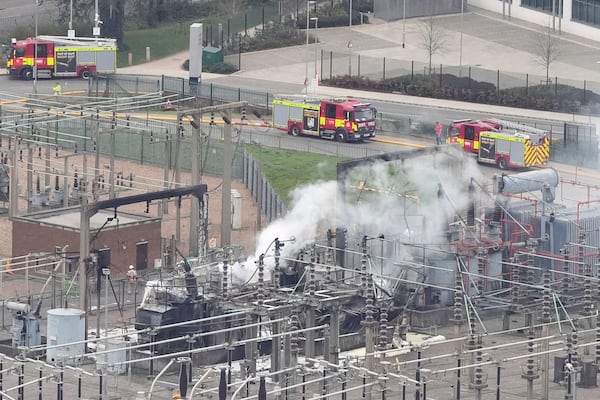 Smoke rises from the North Hyde electrical substation, which caught fire last night, leading to the closure of the Heathrow Airport, in London, Friday March 21, 2025. (Jonathan Brady/PA via AP)