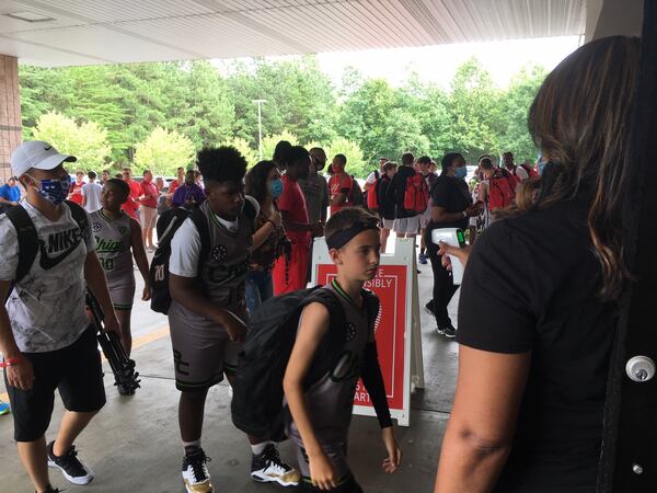 Basketball players at the "Showcase of Champions" youth basketball tournament at the Suwanee Sports Academy in Suwanee have their temperatures scanned before entering the facility June 27, 2020. (AJC photo by Ken Sugiura)