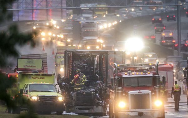 DeKalb County Firefighters emerge from the cab of a burned out truck Thursday morning, Nov. 5, 2015 after putting out a fire that erupted during the early morning commute.