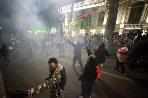 Protesters pour into the streets during a rally outside the parliament's building to protest the government's decision to suspend negotiations on joining the European Union for four years in Tbilisi, Georgia, on Saturday, Nov. 30, 2024. (AP Photo/Zurab Tsertsvadze)