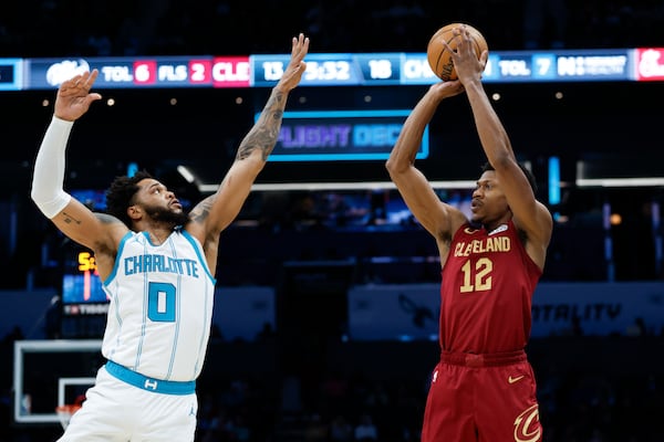 Cleveland Cavaliers forward De'Andre Hunter (12) shoots over Charlotte Hornets forward Miles Bridges (0) during the first half of an NBA basketball game in Charlotte, N.C., Friday, March 7, 2025. (AP Photo/Nell Redmond)