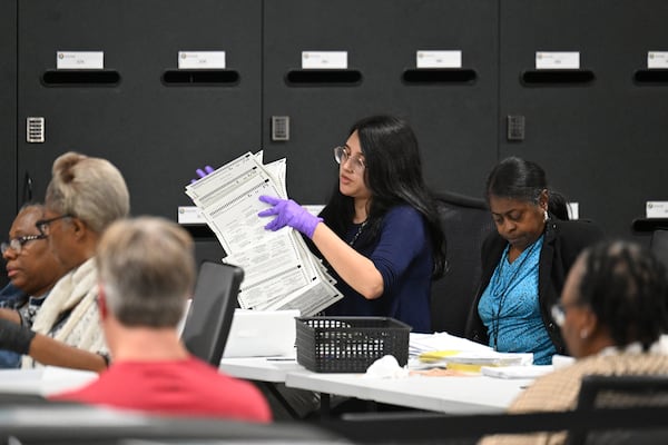 Gwinnett County election workers look over provisional ballots in Lawrenceville on Tuesday.