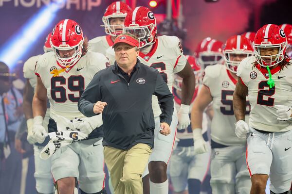 Georgia Bulldogs head coach Kirby Smart leads his team onto the field to face the Alabama Crimson Tide in the SEC Championship football game at the Mercedes-Benz Stadium in Atlanta, on Saturday, Dec. 2, 2023. (Jason Getz/The Atlanta Journal-Constitution/TNS)