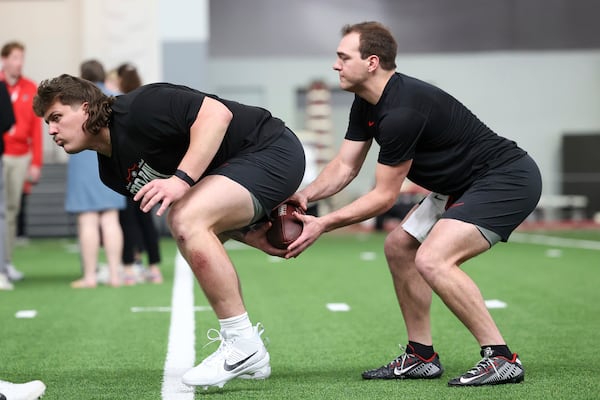 Georgia's Tate Ratledge, left, runs a drill with Gunner Stockton, right, during the school's NFL Pro Day, Wednesday, March, 12, 2025, in Athens, Ga. (AP Photo/Colin Hubbard)