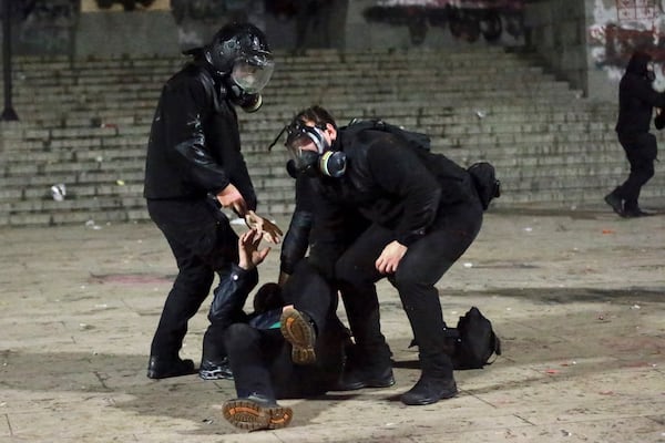 Police detain a protester during a rally outside the parliament's building to protest the government's decision to suspend negotiations on joining the European Union for four years in Tbilisi, Georgia, early Sunday, Dec. 1, 2024. (AP Photo/Zurab Tsertsvadze)