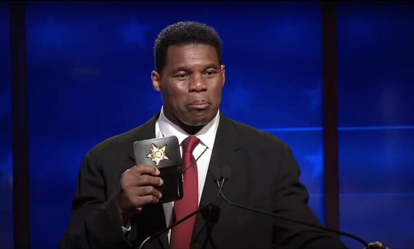 Republican U.S. Senate hopeful Herschel Walker has faced criticism for statements made before entering the Senate race where he said falsely that he worked in law enforcement, including the FBI. In response, Walker brandished an honorary deputy badge he said he had received for his work with police. (Screengrab)