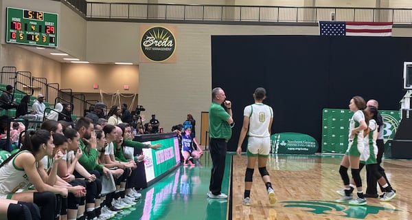 Coach Gene Durden instructs Cybele Forbes during a stoppage against Chapel Hill in their first-round playoff game on Feb. 18, 2025.