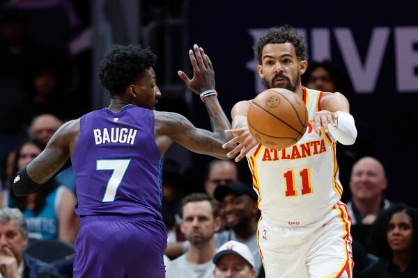 Atlanta Hawks guard Trae Young (11) passes against Charlotte Hornets guard Damion Baugh during the first half of an NBA basketball game in Charlotte, N.C., Tuesday, March 18, 2025. (AP Photo/Nell Redmond)