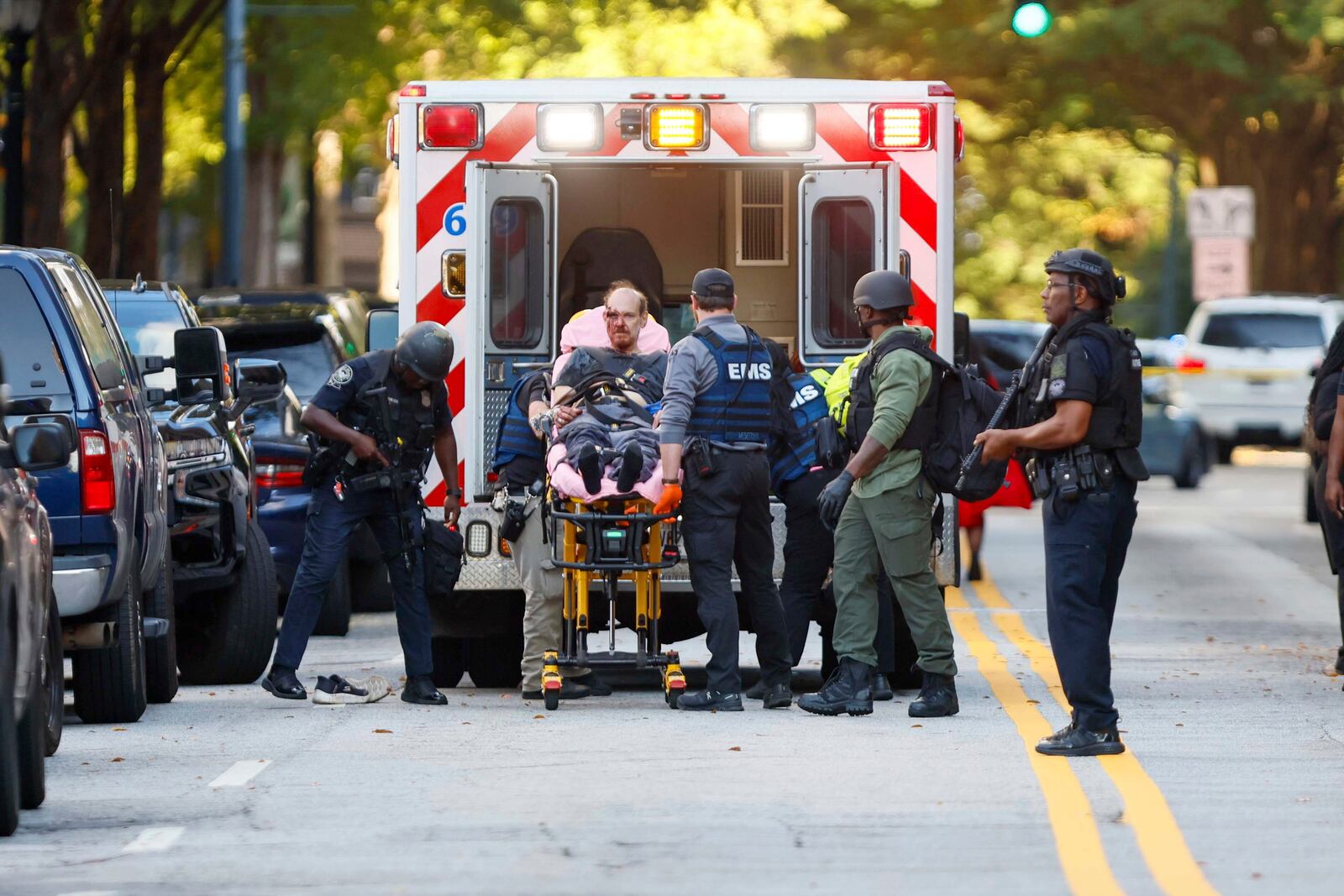 After an hours-long standoff, a suspect is taken into custody with visible injuries on 14th Street outside the Four Seasons Hotel in Midtown in Atlanta, Tuesday, Oct. 29, 2024. (Miguel Martinez/Atlanta Journal-Constitution via AP)