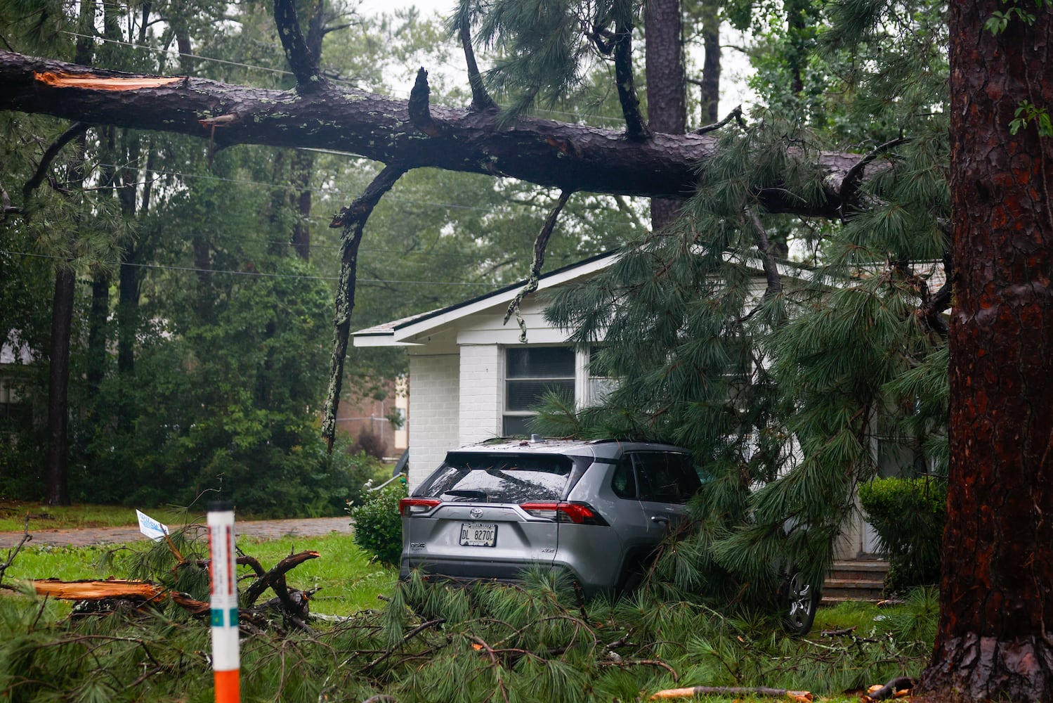 A fallen pine tree nearly damaged a car in a north side neighborhood in Valdosta, showing the aftermath of Tropical Storm Debby’s path through south Georgia on Monday, August 5, 2024.
(Miguel Martinez / AJC)