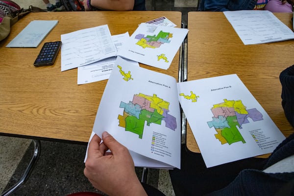 Concerned parents and students gather at Tri-Cities High School to review proposed redistricting maps on Wednesday. Fulton County officials sought their feedback on three different attendance options should Parklane close next year.  Jenni Girtman for the AJC