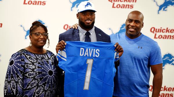 Amy and John Davis pose with their son Jarrad Davis, the Detroit Lions first round draft pick, as he is introduced Friday, April 28, 2017, in Allen Park, Mich.