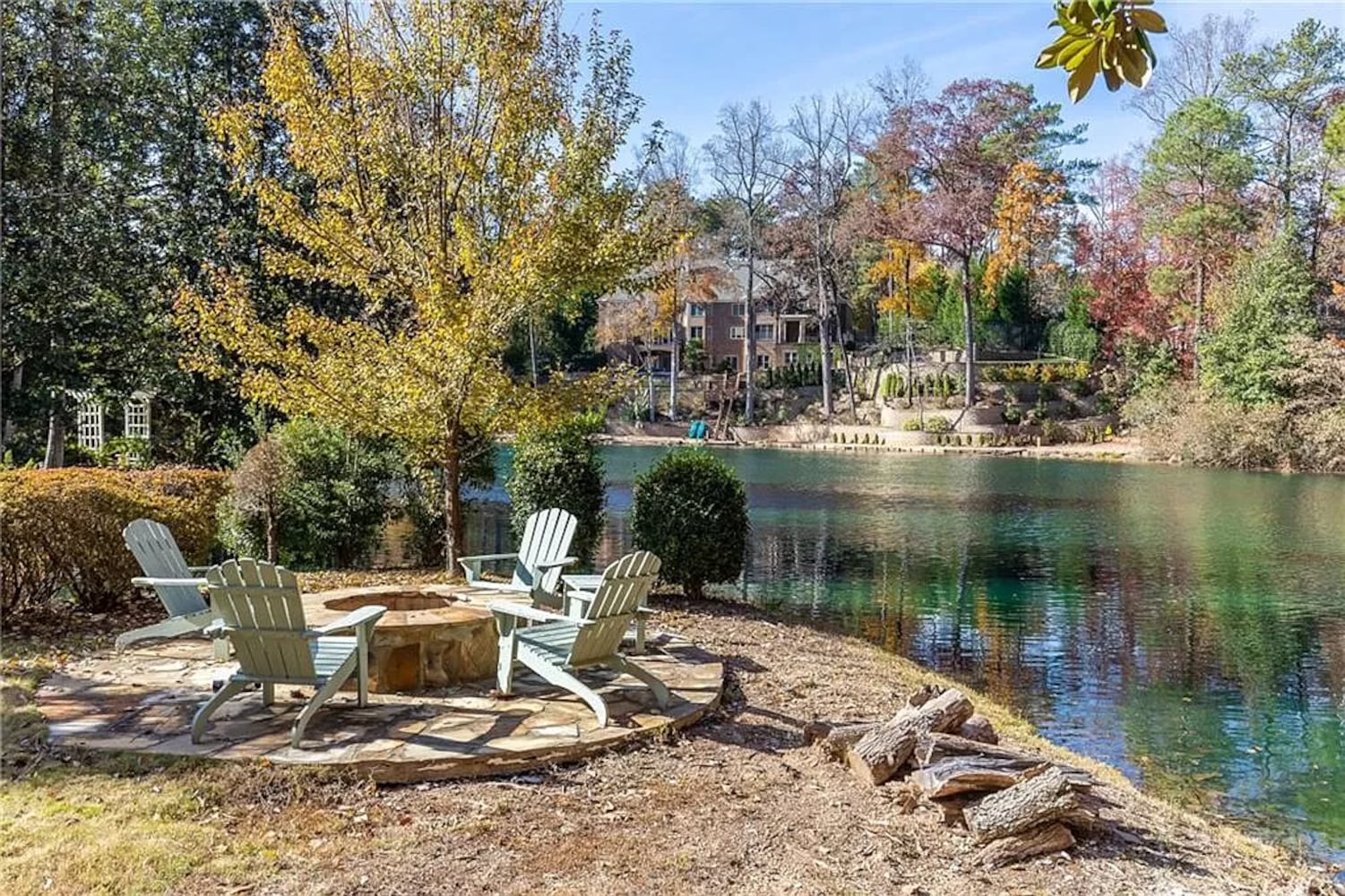 Enjoy resort-style living ITP at this $8.7M estate with private lake