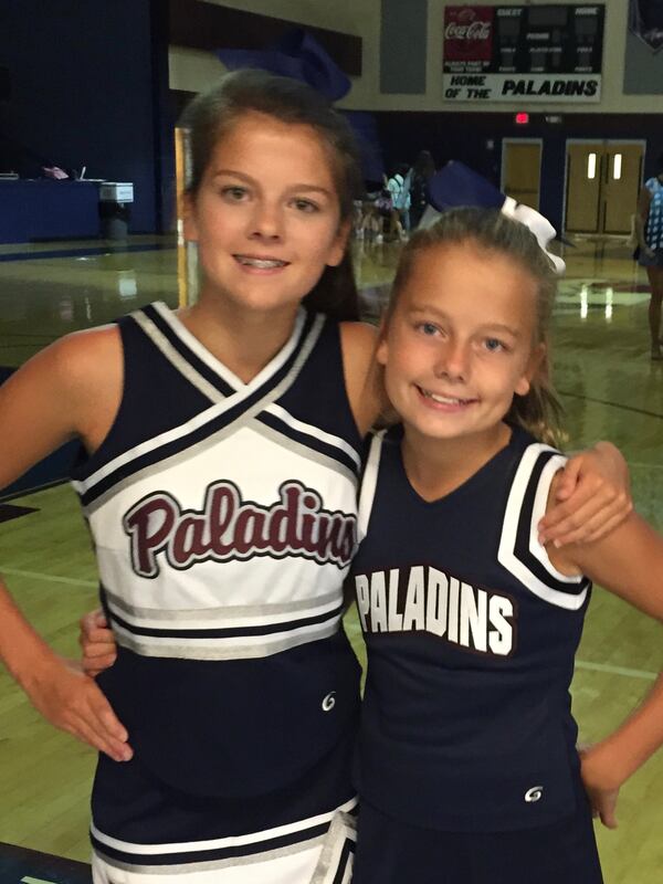 Sydney Rountree (left) and her sister Reese Rountree of Milton grew up in a cheerleading family. Reese is a cheerleader for the Georgia Bulldogs for the 2024 football season. Her sister Peyton is a cheerleader for Ole Miss this season. Those teams will meet Nov. 9 in Oxford, Mississippi, with the sisters cheering on opposing sidelines. This photo was taken when Sydney was 13 and Reese was 11. (Photo courtesy of Rountree family)