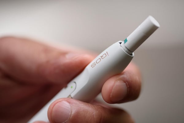 A Philip Morris International iQOS electronic cigarette is held for a photograph in Tokyo on Aug.23, 2016. MUST CREDIT: Bloomberg photo by Akio Kon.