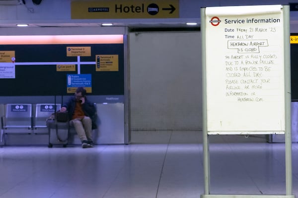 A handwritten sign at a Heathrow Airport tube station in London indicates the airport is closed on Friday March 21, 2025, following a fire at the North Hyde electrical substation the previous night.(AP Photo/Alberto Pezzali)