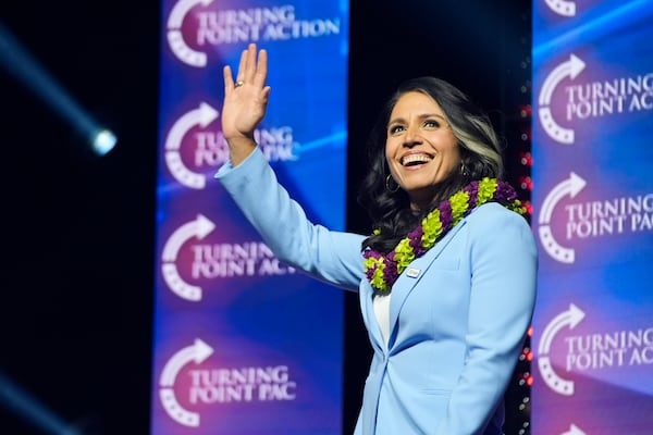 FILE - Former Democratic Rep. Tulsi Gabbard waves as she arrives to speak before Republican presidential nominee former President Donald Trump during a campaign rally at Thomas & Mack Center, Oct. 24, 2024, in Las Vegas. (AP Photo/Alex Brandon, File)