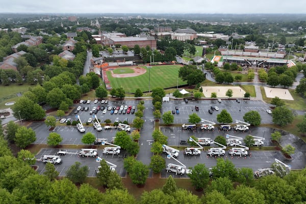 Utility trucks are staged at Mercer University campus parking lot, Thursday, September 26, 2024, in Macon. Hurricane Helene is set to make landfall as a major storm in Florida on Thursday evening, bringing rain and damaging wind to Georgia. Emergency officials are warning of fallen trees, downed power lines, shuttered roads and even the possibility of landslides as Helene makes its way through Georgia overnight. (Hyosub Shin / AJC)